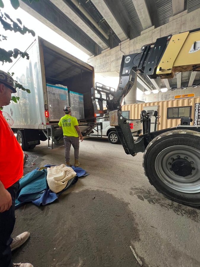 Freight being loaded into a trailer by crane