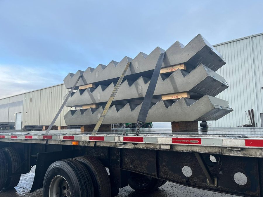 Flatbed trailer loaded with precast concrete freight